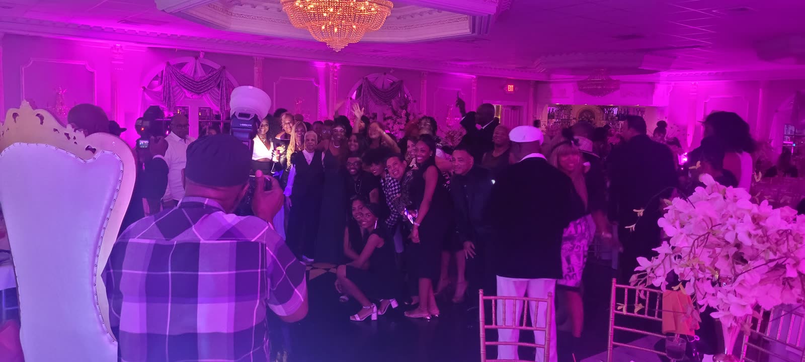 Crowded dance floor with pink lighting